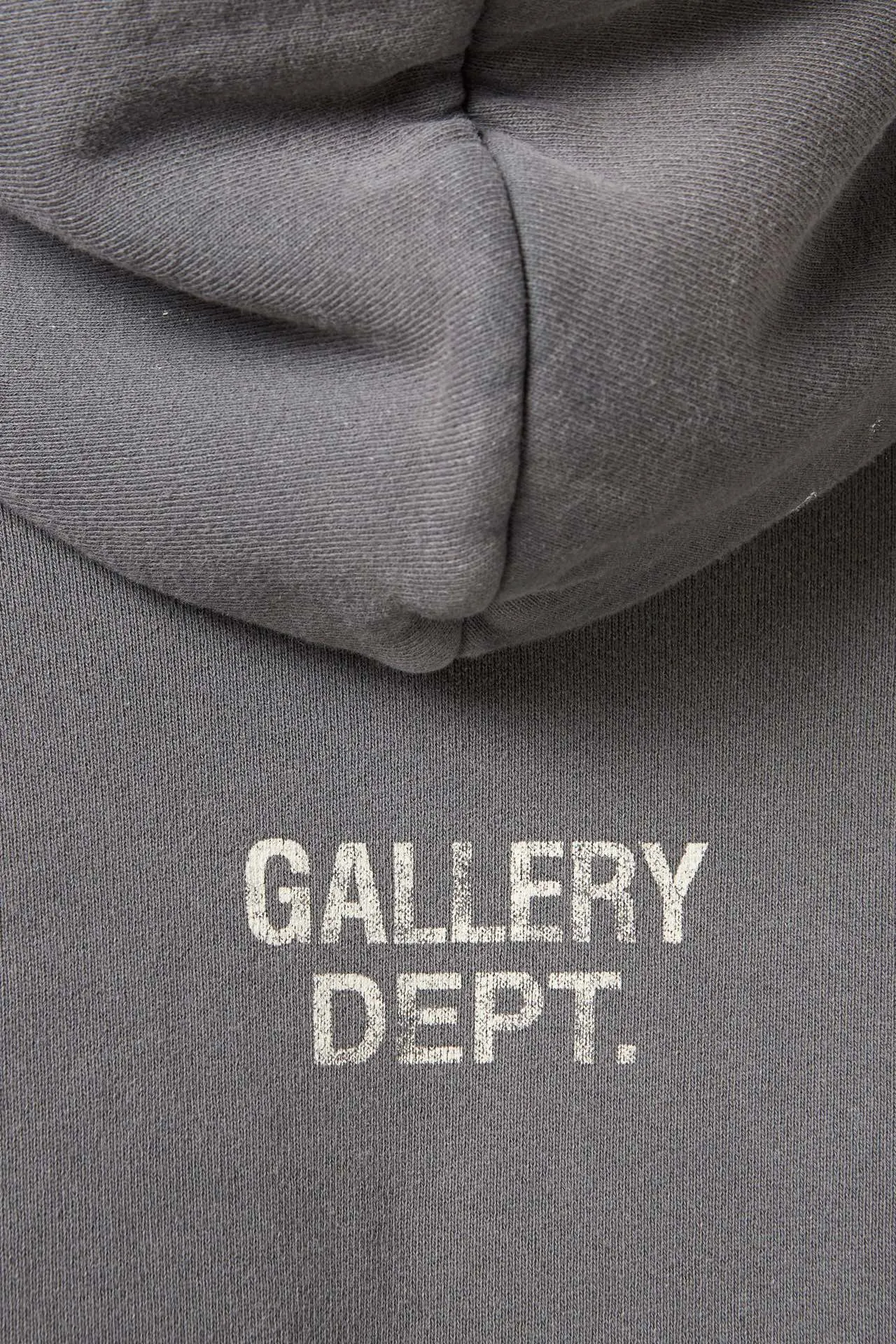 GALLERY DEPT. 90'S RECYCLE HOODIE WASHED BLACK 90'S washed hoodie with distressed eco-friendly slogans. Washed black S-XL. Ready-made garments are washed and dyed again. Multiple spots throughout the body are spray-faded. The ribs are cut and worn.